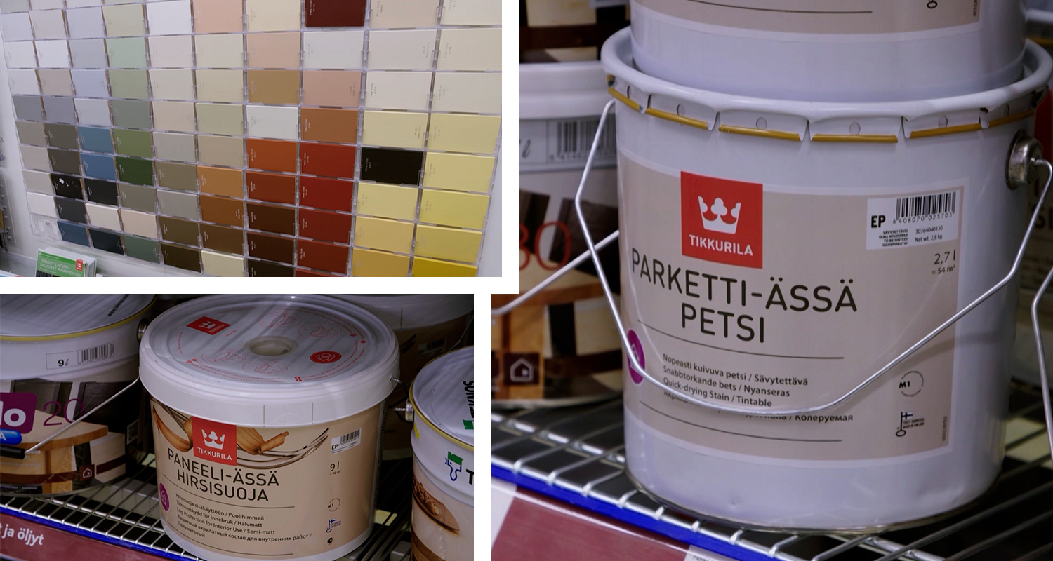 Monivärinen sävykartanäyttö ja hyllyssä Tikkurila-paneeli- sekä parkettipetsipurkkeja.