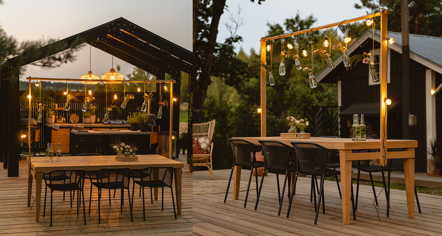 Puutarhapöytä koristetelineellä kesäkeittiön terassilla kesäillan hämärtyessä.