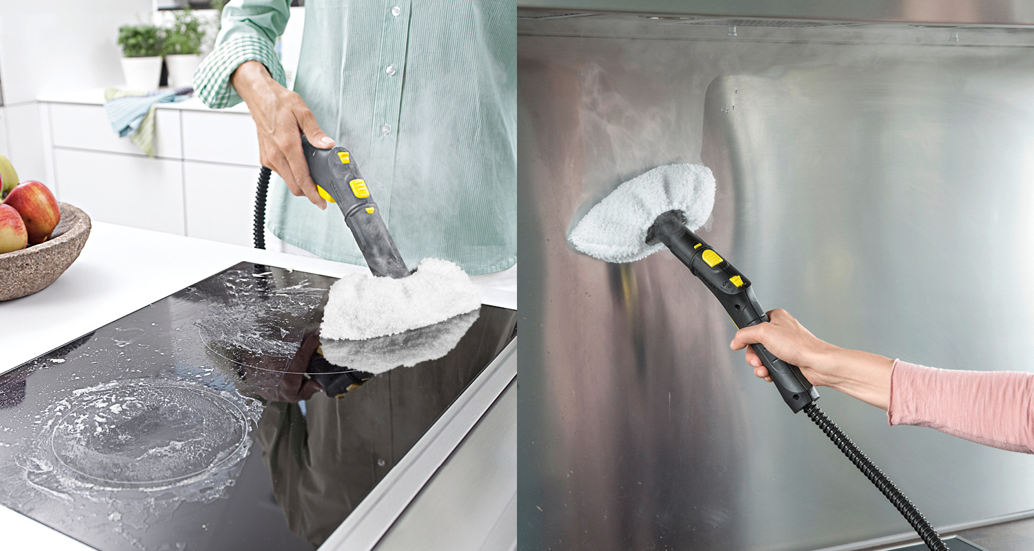 Kelta-musta höyrypuhdistin pyyhkii mustaa lasi-keramiikkaliesitasoa ja teräspintaa.