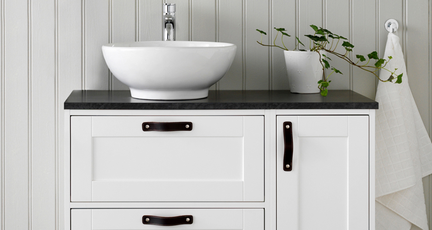 Mustat nahkavetimet romanttisen allaskaapin alaosassa. 