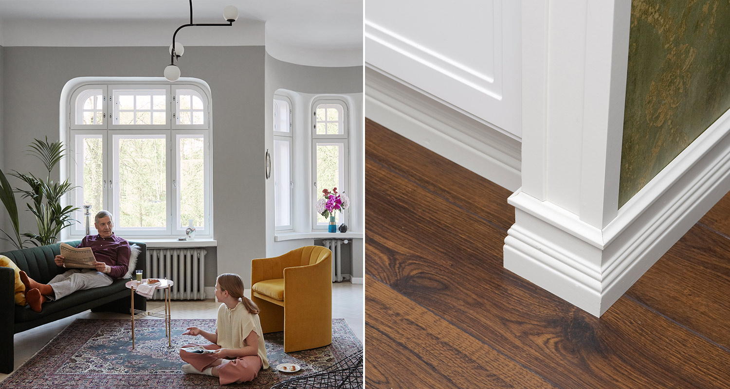 Mies ja tyttö olohuoneessa ja koristeellinen jalkalista