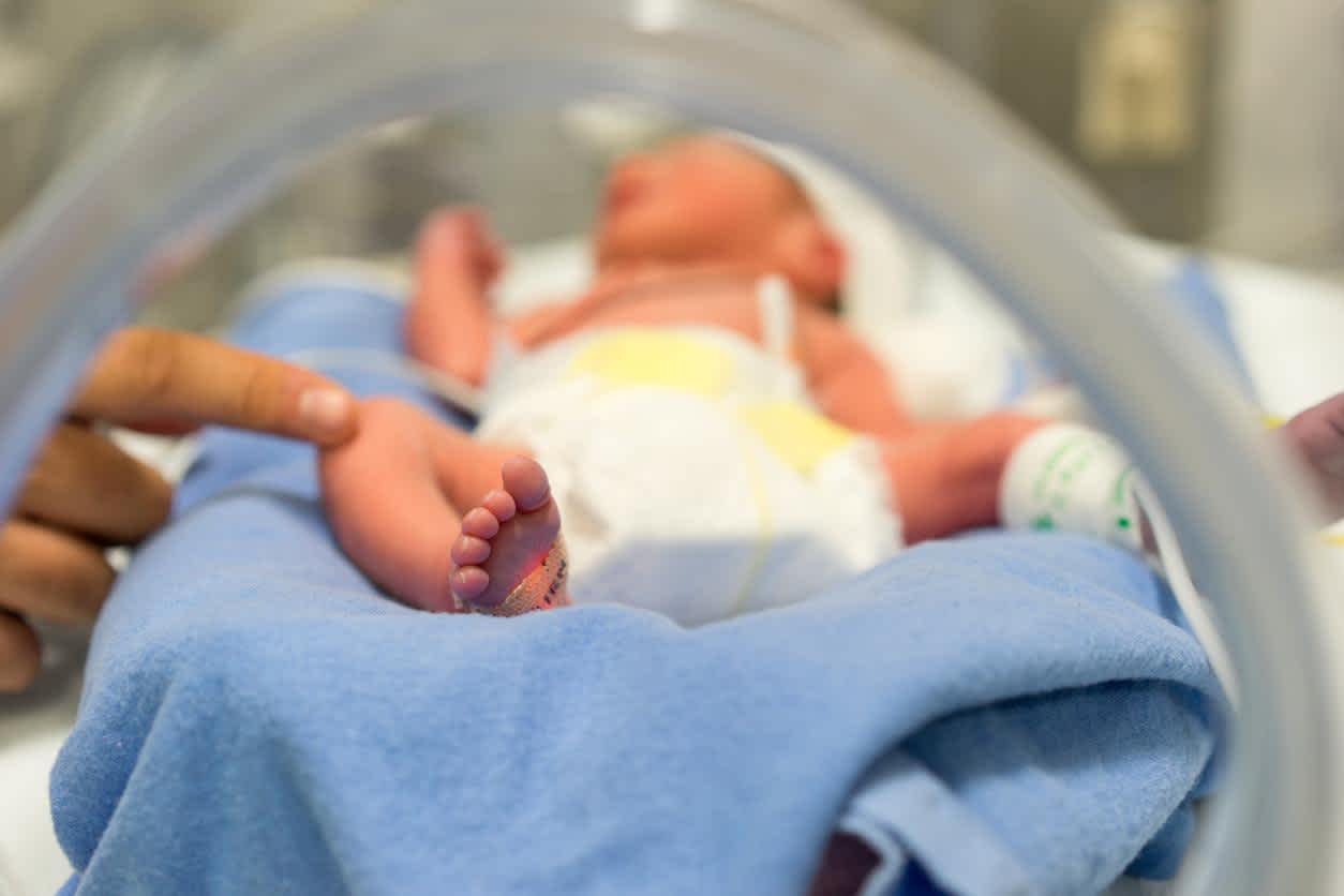 Baby with labor and delivery nurse in the hospital