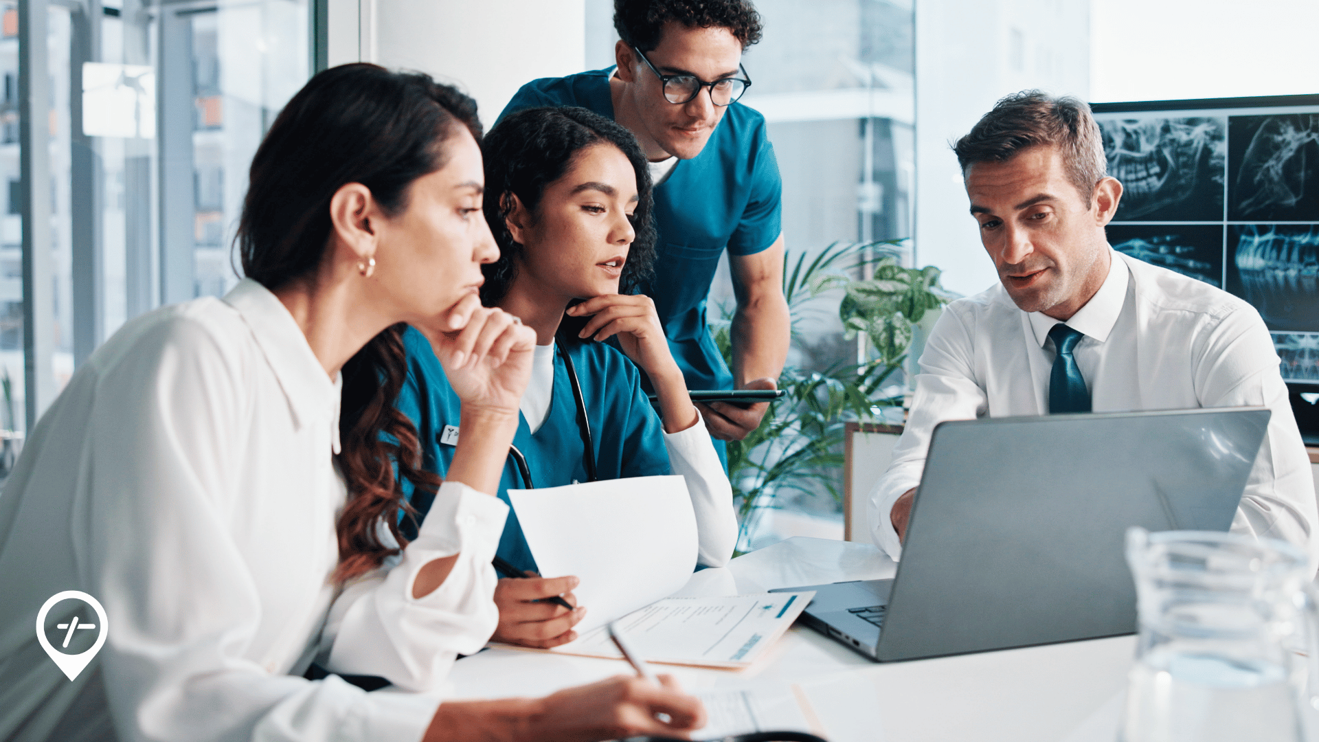 Chief nursing officer and chief operating officer meeting with nurses in a hospital conference room to discuss workforce planning and operations.