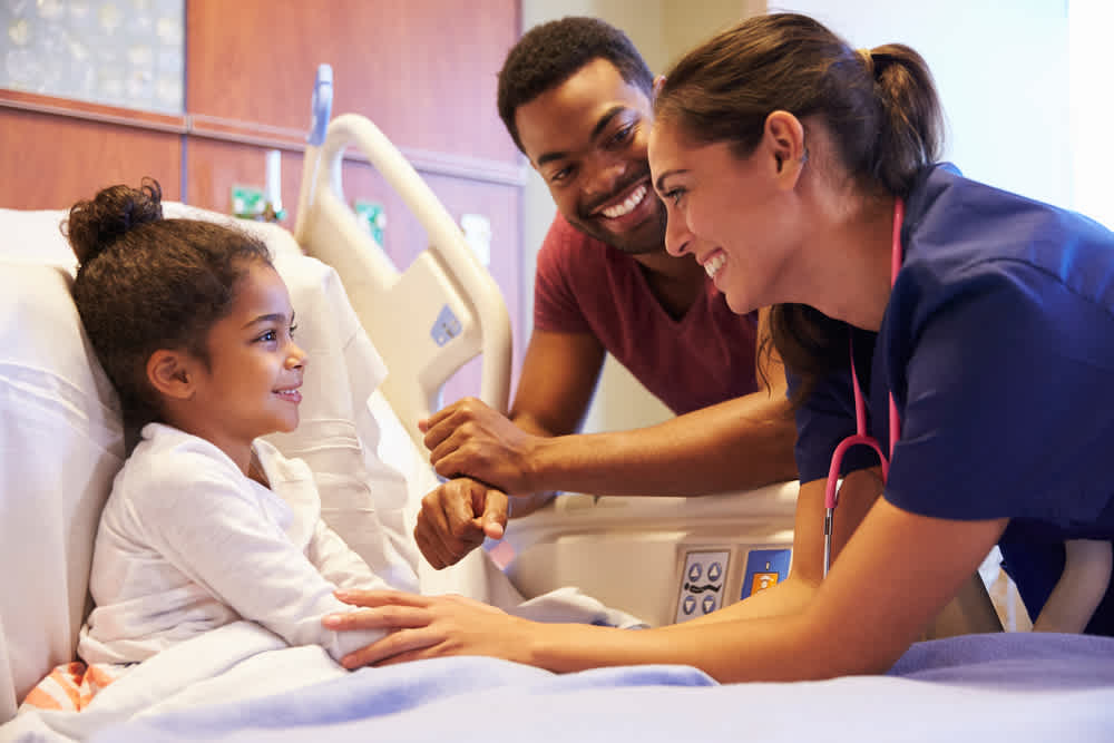 Pediatric nurse with child and father