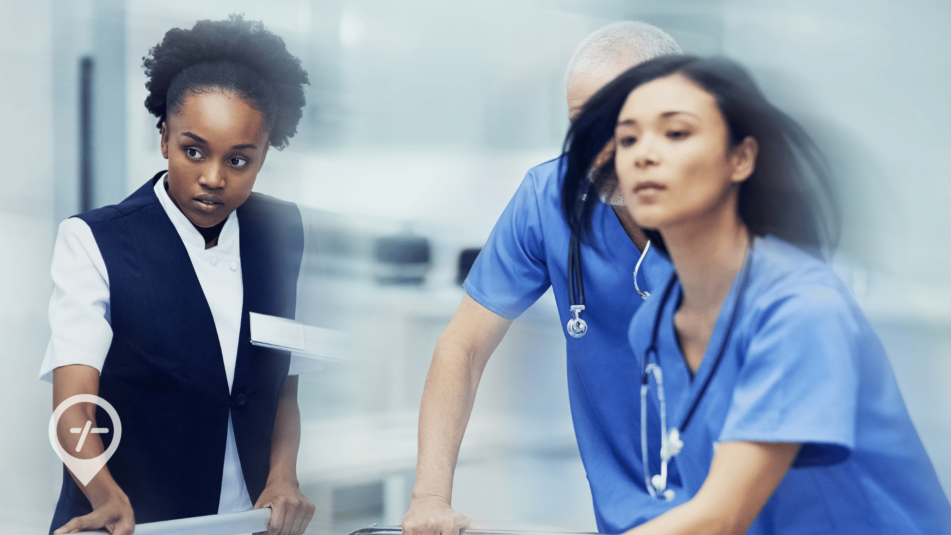 An image of nurses quickly moving a patient's bed down a hospital hallway.