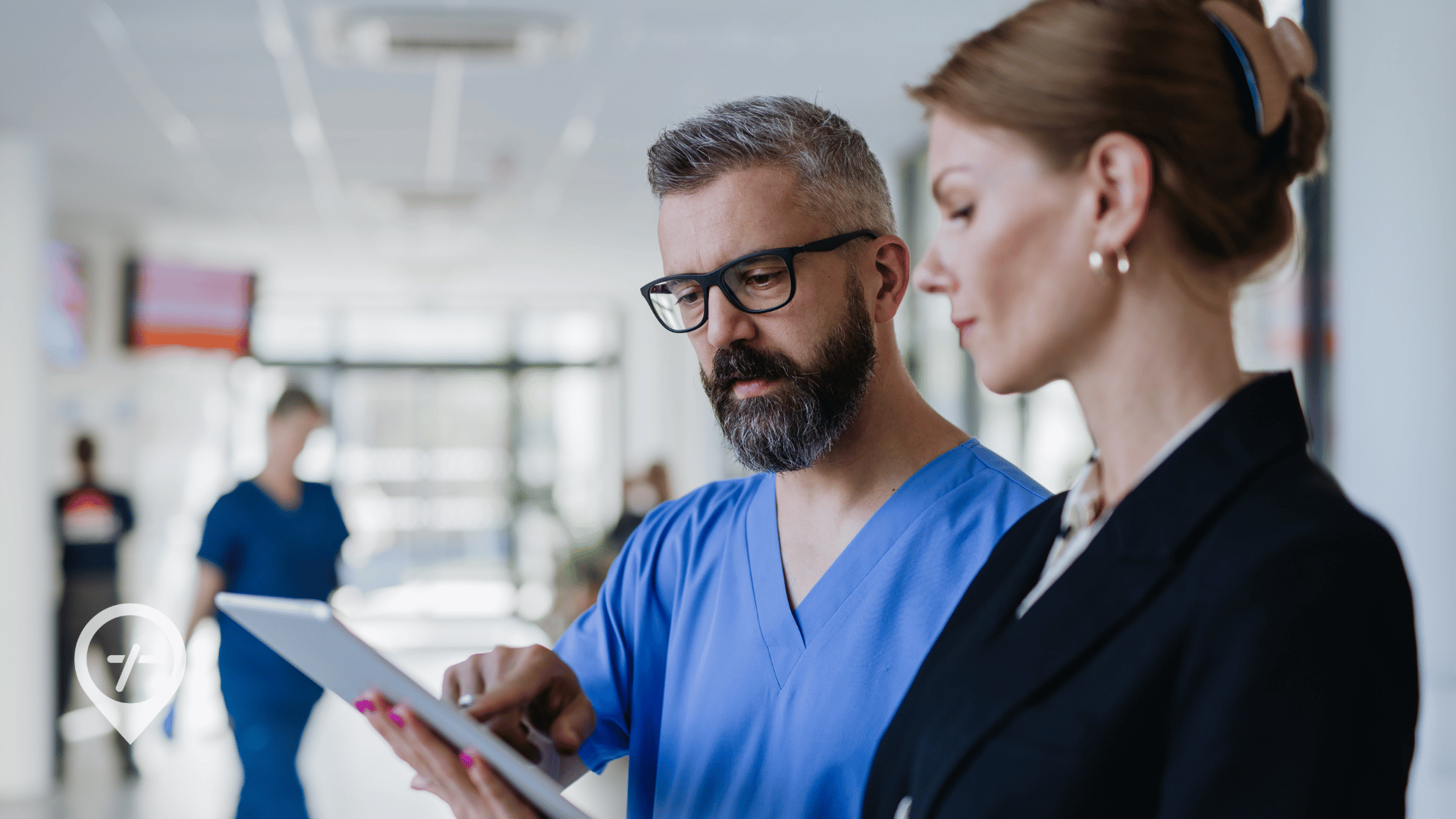 Nurse speaking with a chief nursing officer about predictive analytics and proactive scheduling to manage hospital labor costs.