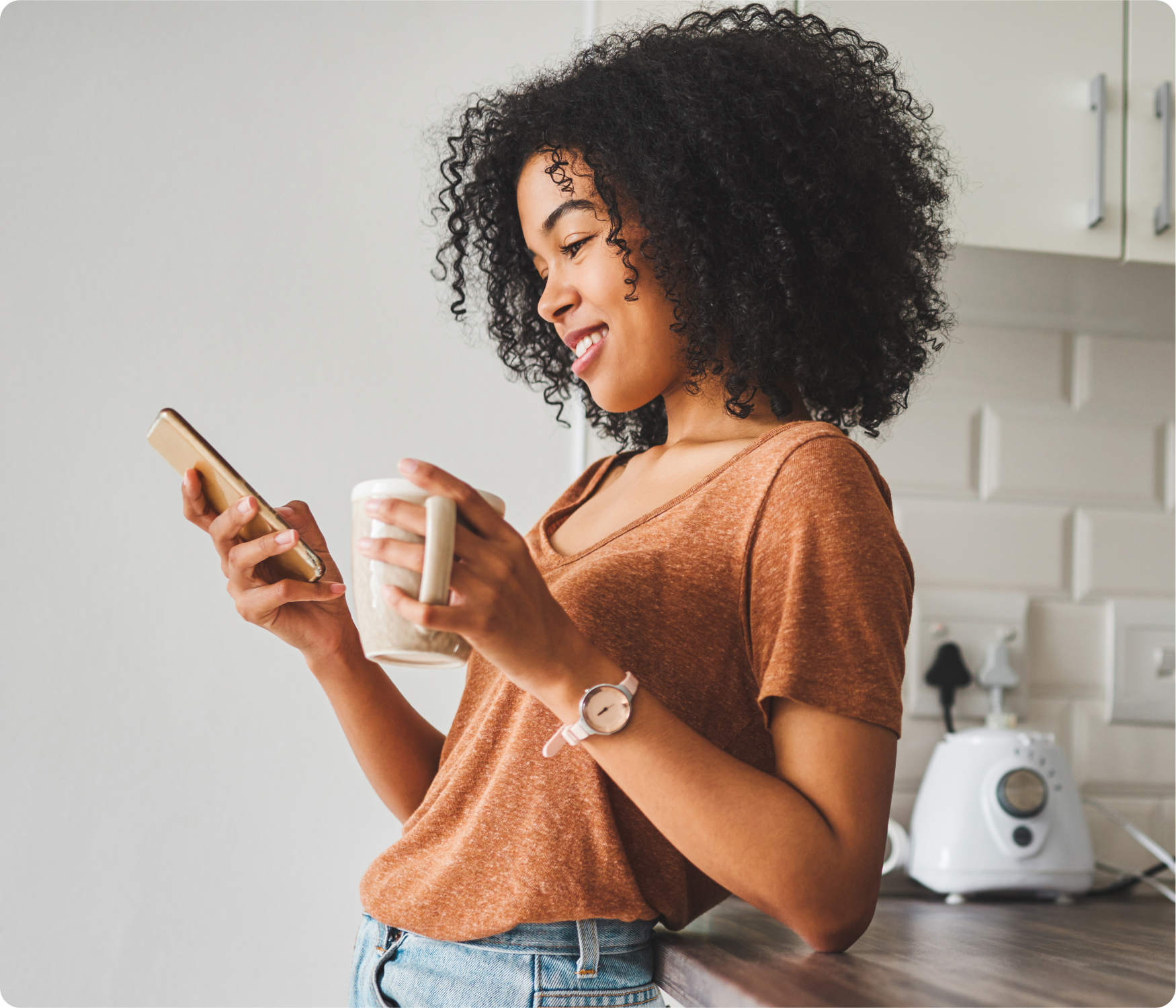 woman using the ShiftMed app on her phone while having morning coffee
