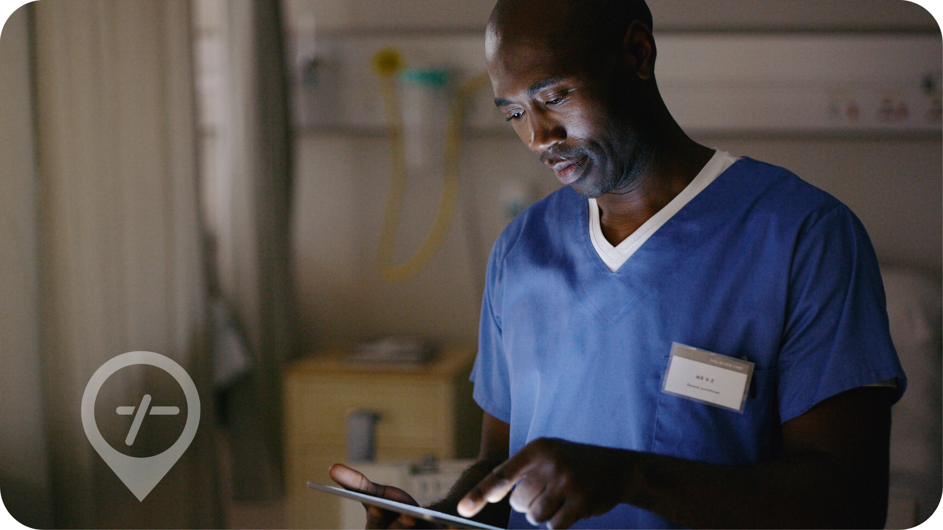 African American male nurse inputting patient details to electronic medical record system. 