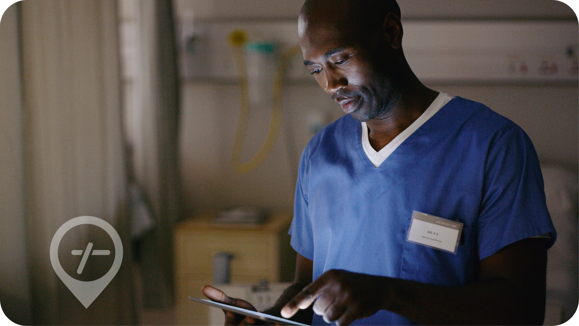 African American male nurse inputting patient details to electronic medical record system.