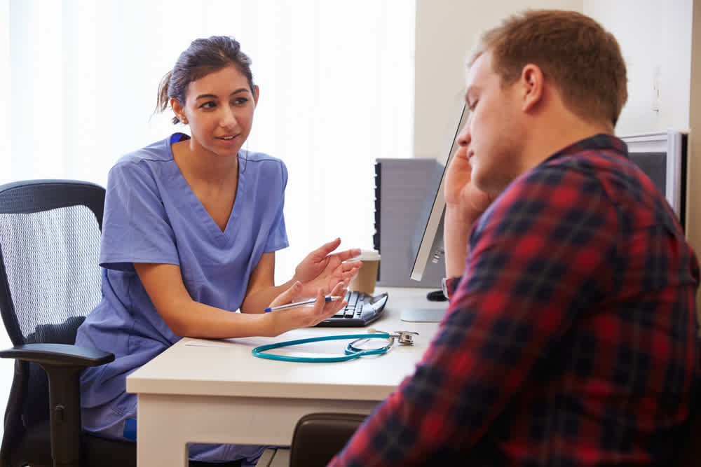 Mental health nurse speaking to a patient