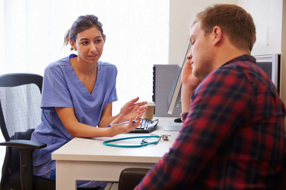 Mental health nurse speaking to a patient