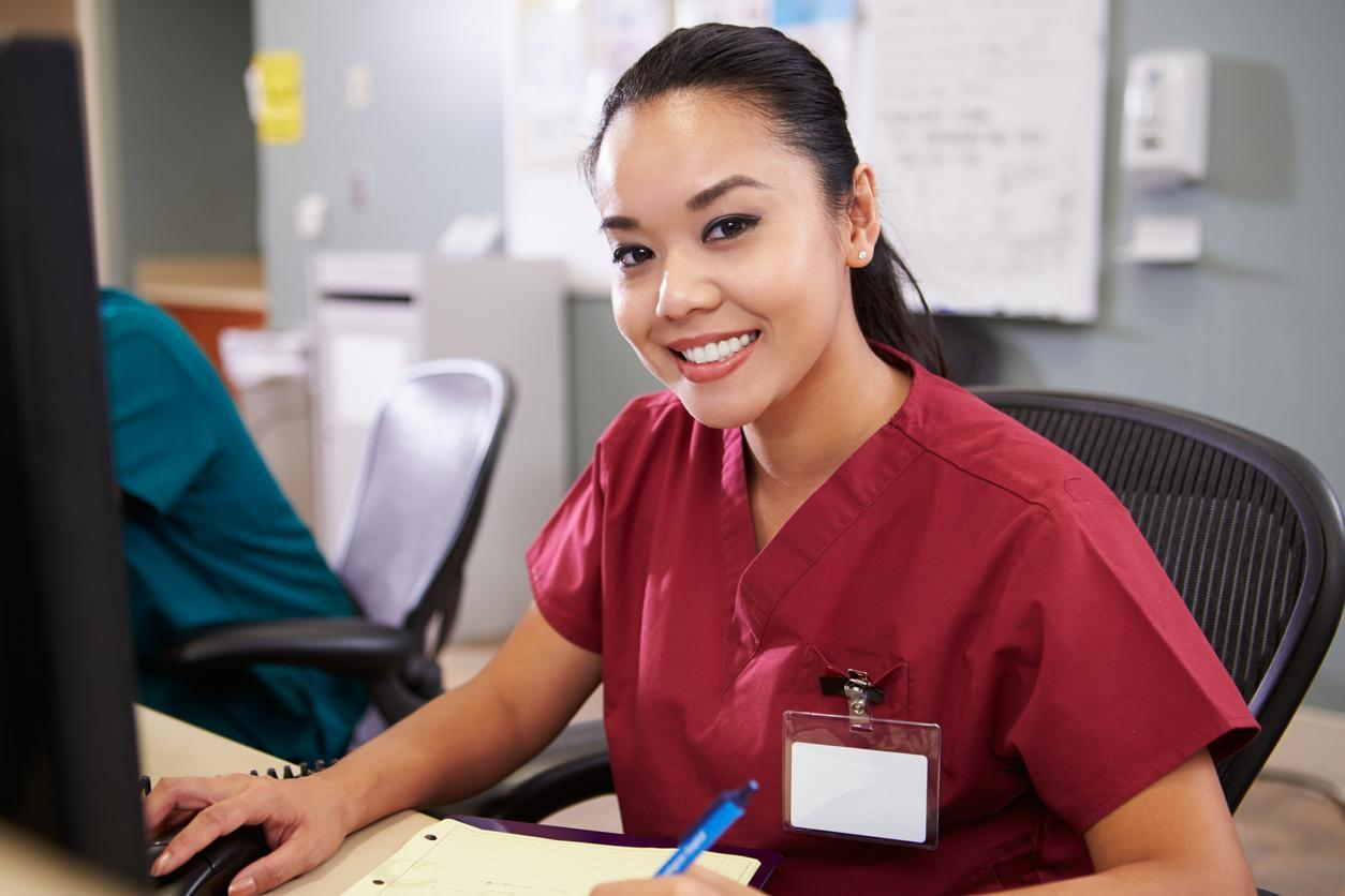 Public health nurse sat at desk