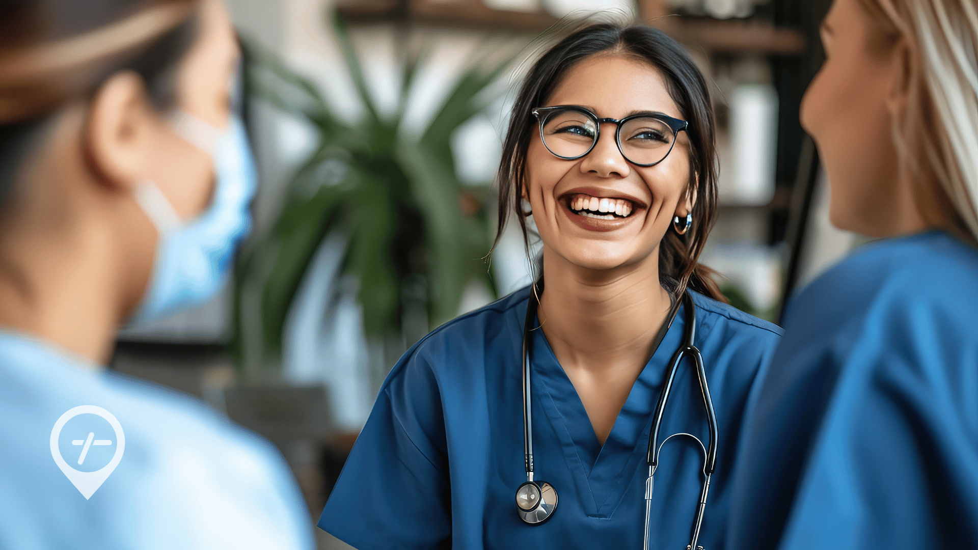 A nurse smiles during a conversation with hospital colleagues to highlight how it's possible to pick up nursing shifts without burning out. 