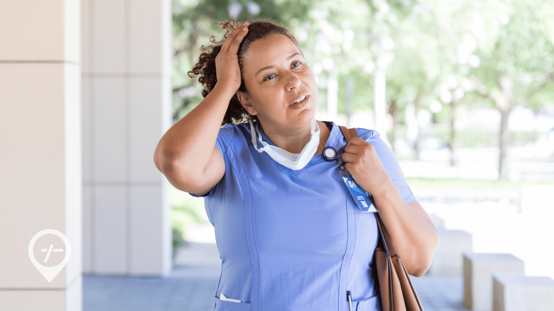 A nurse walking outside during the summer holding her hand up to her head.