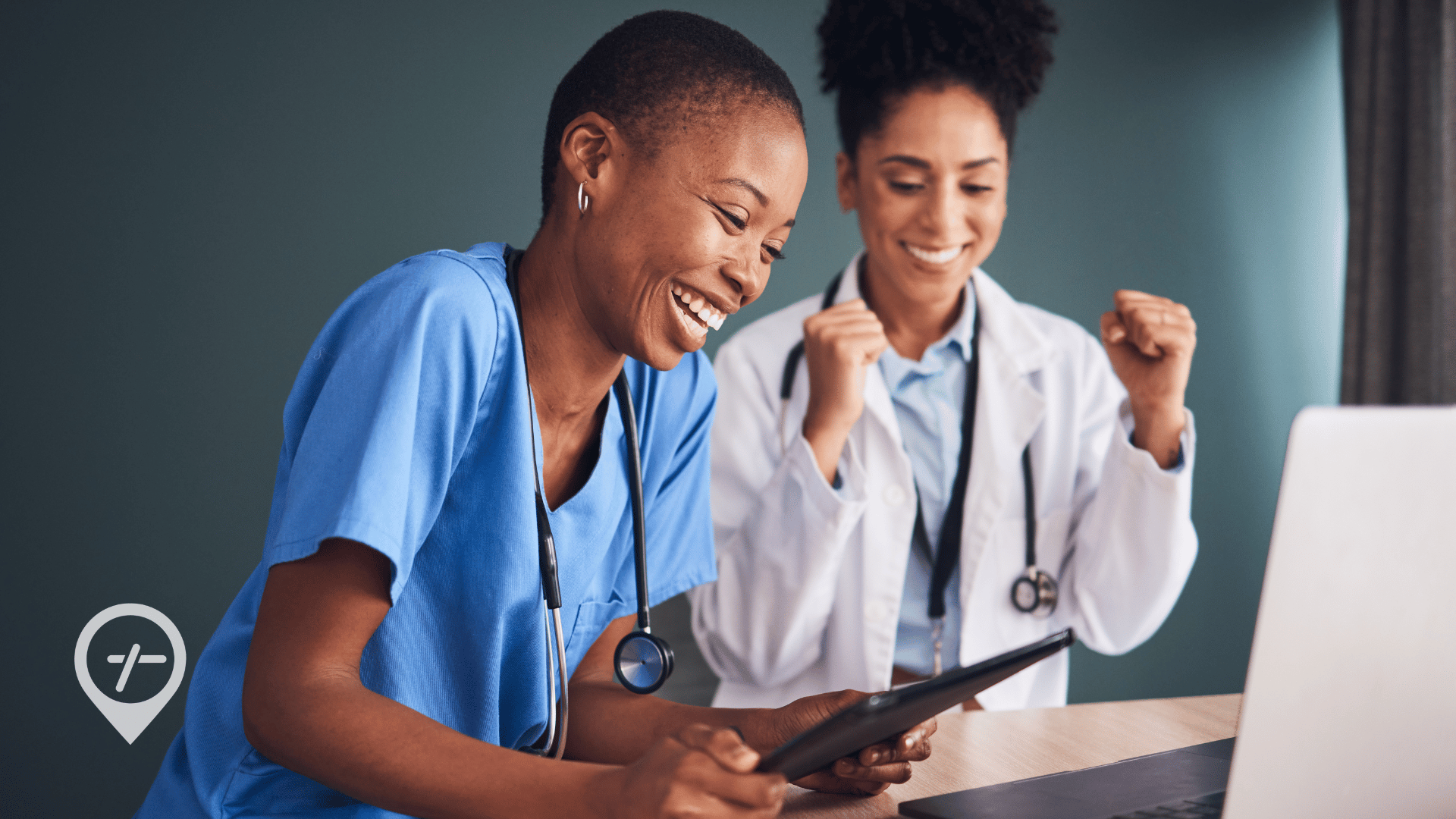 A nurse and a doctor at a desk working on achievable goals for 2026.