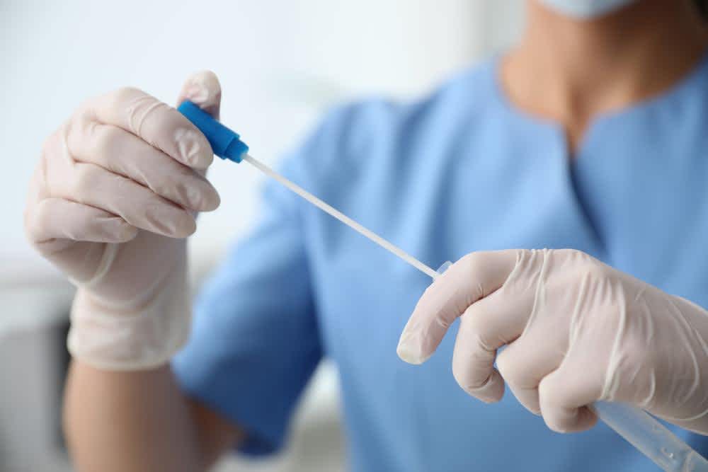 Forensic nurse checking a sample