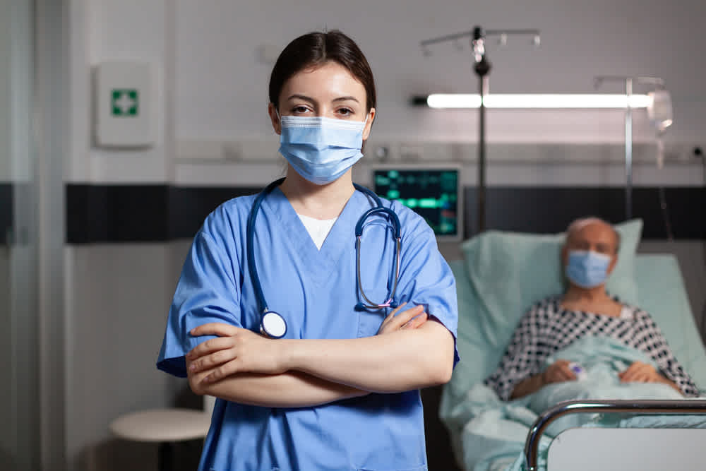 Trauma nurse standing in front of a patient’s bed