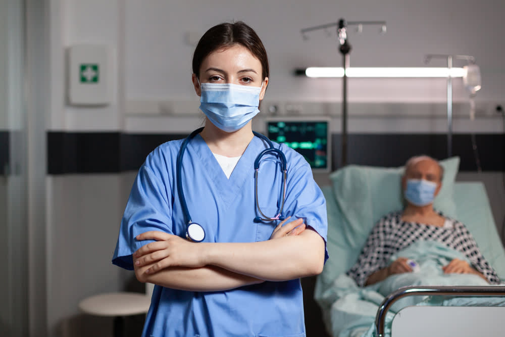 Trauma nurse standing in front of a patient’s bed