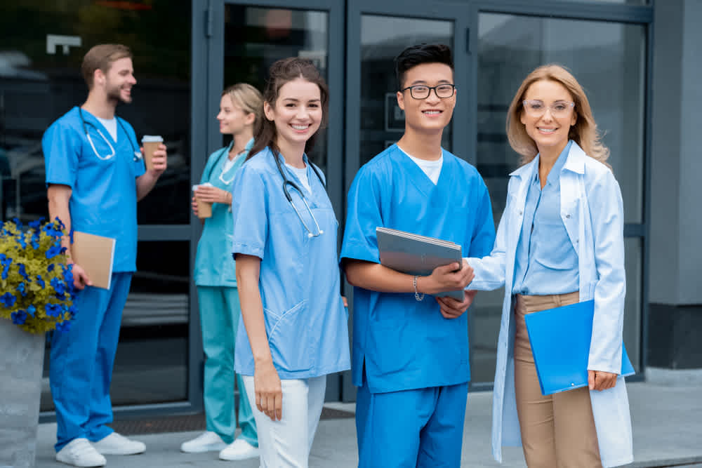 Nurses standing outside a hospital