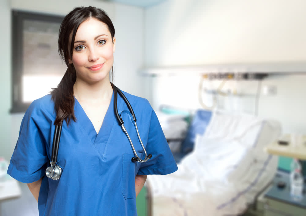 Medical assistant standing in a ward