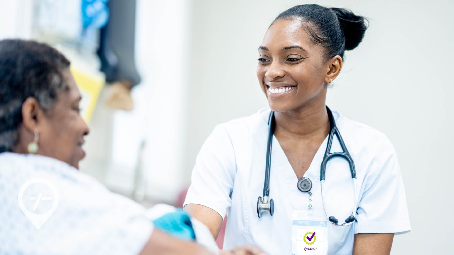 A nurse meeting with an elderly patient in a hospital room. 