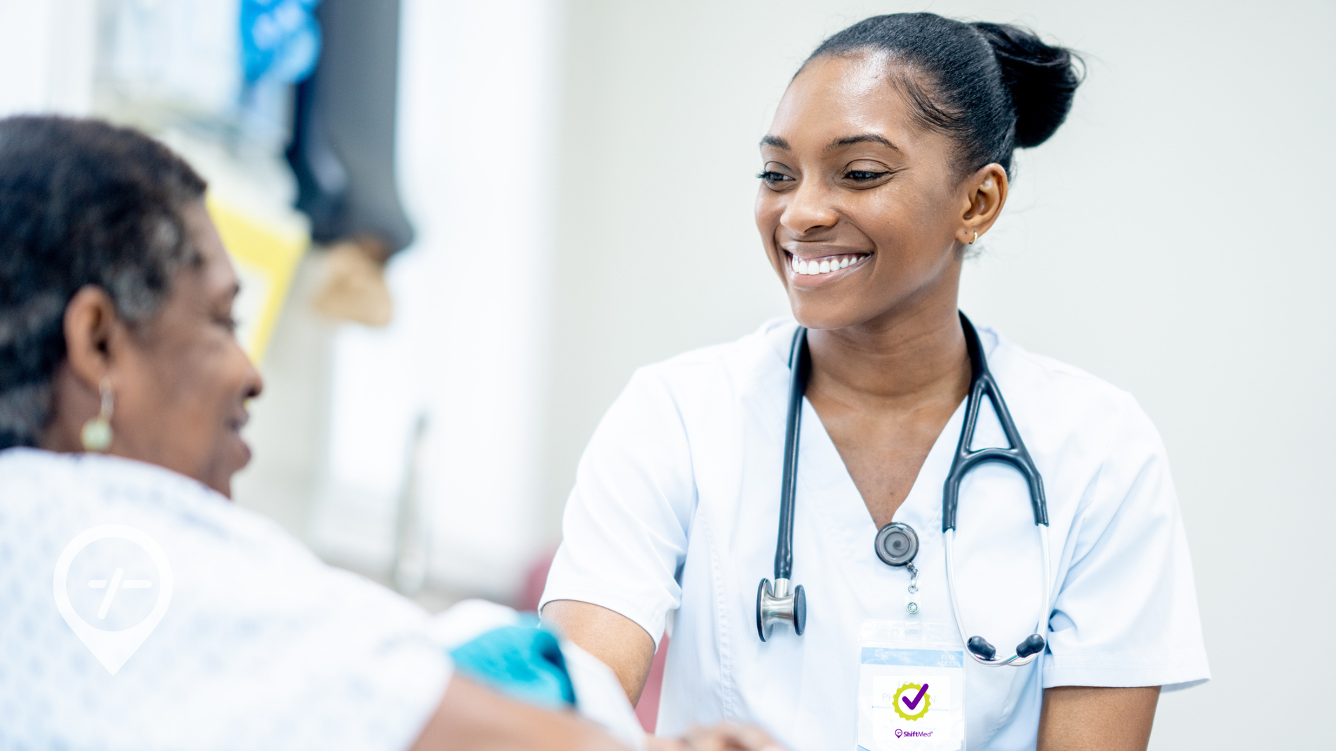 A nurse meeting with an elderly patient in a hospital room.