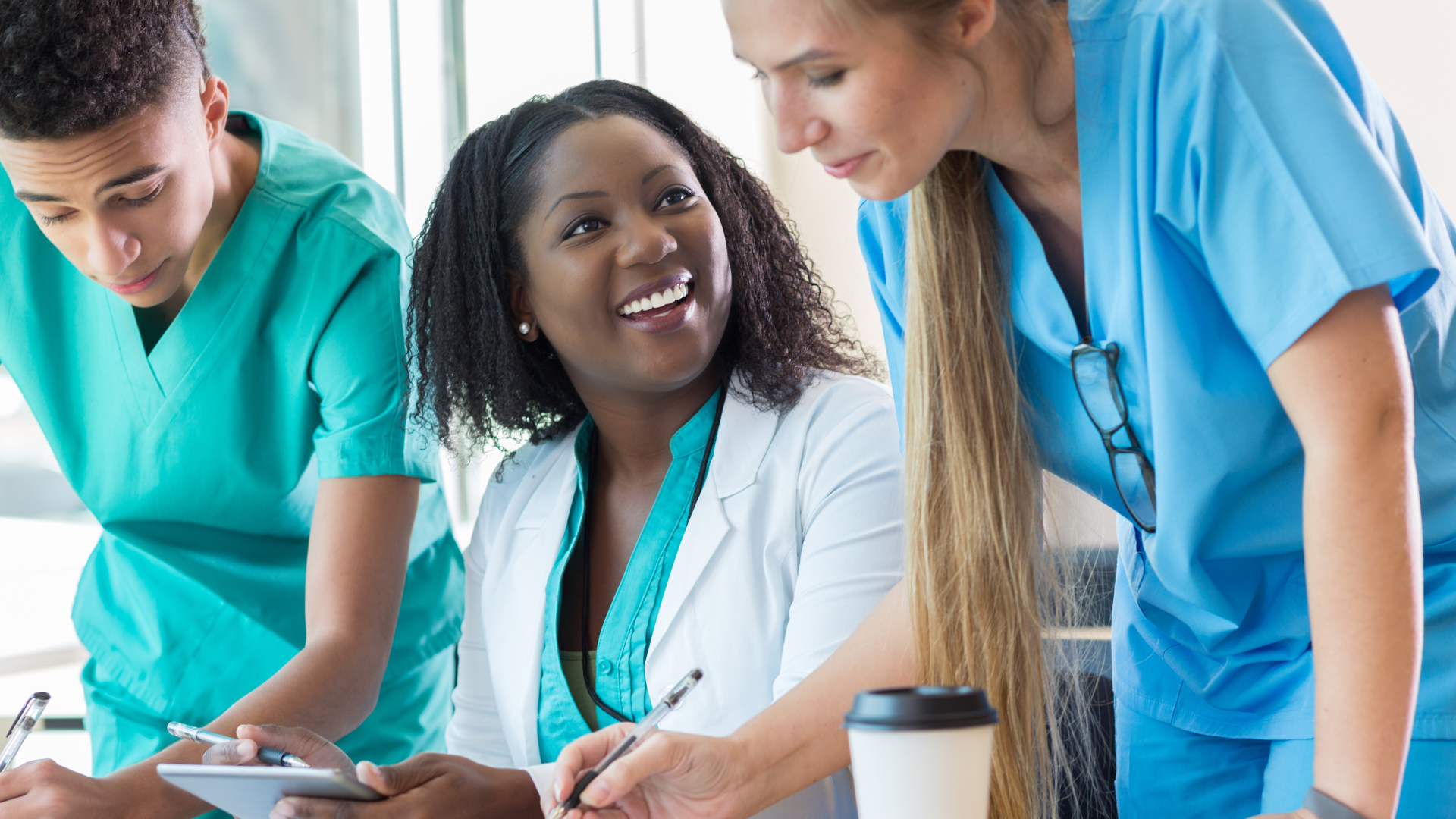 Three nurses demonstrating effective communication at work.