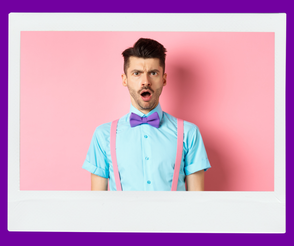 A man wearing a blue bow tie and pink suspenders with his jaw dropped.  