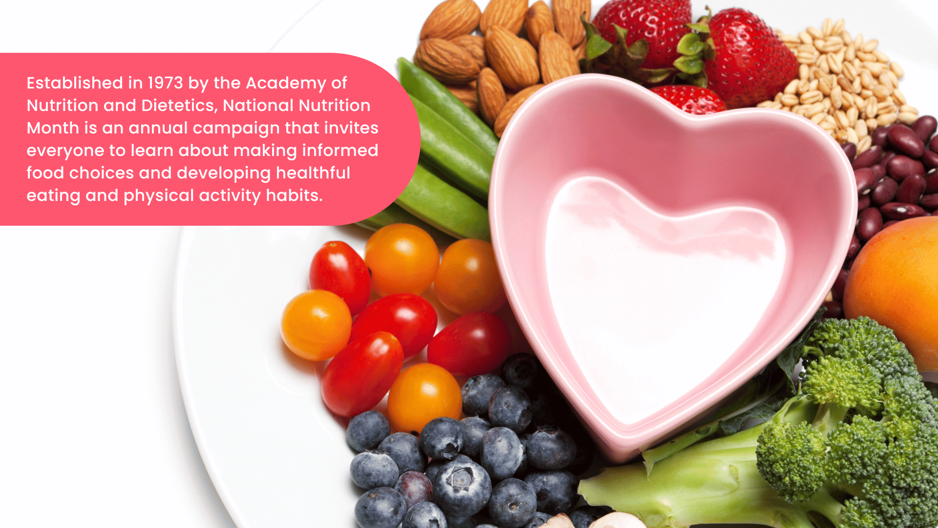 The image shows a plate with fruits, vegetables, and nuts with a heart-shaped bowl in the middle. It includes text that describes National Nutrition Month as an annual campaign that started in 1973. 