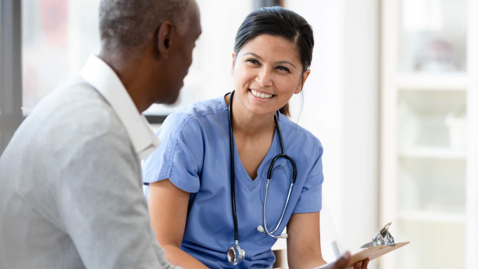 A nurse discusses lab results with a patient.