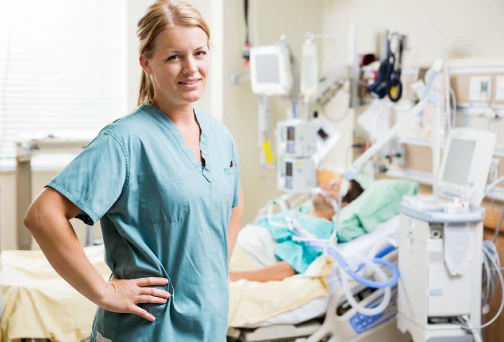 ICU Nurse standing near a patient