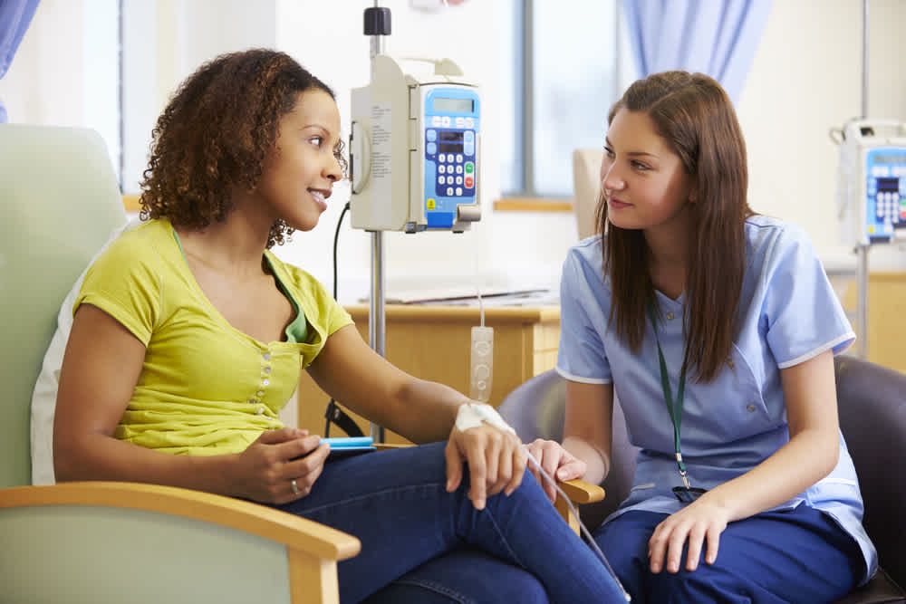Oncology nurse helping patient during chemotherapy