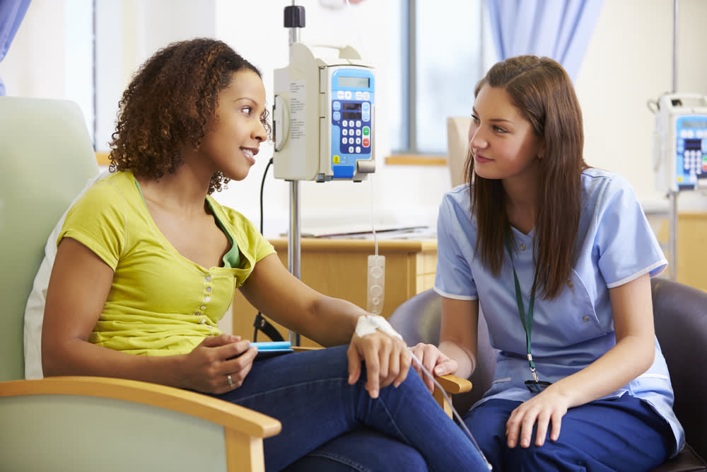Oncology nurse helping patient during chemotherapy