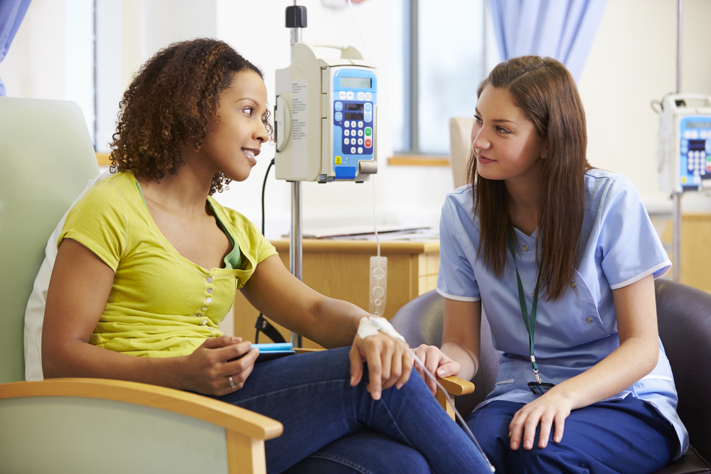 Oncology nurse helping patient during chemotherapy