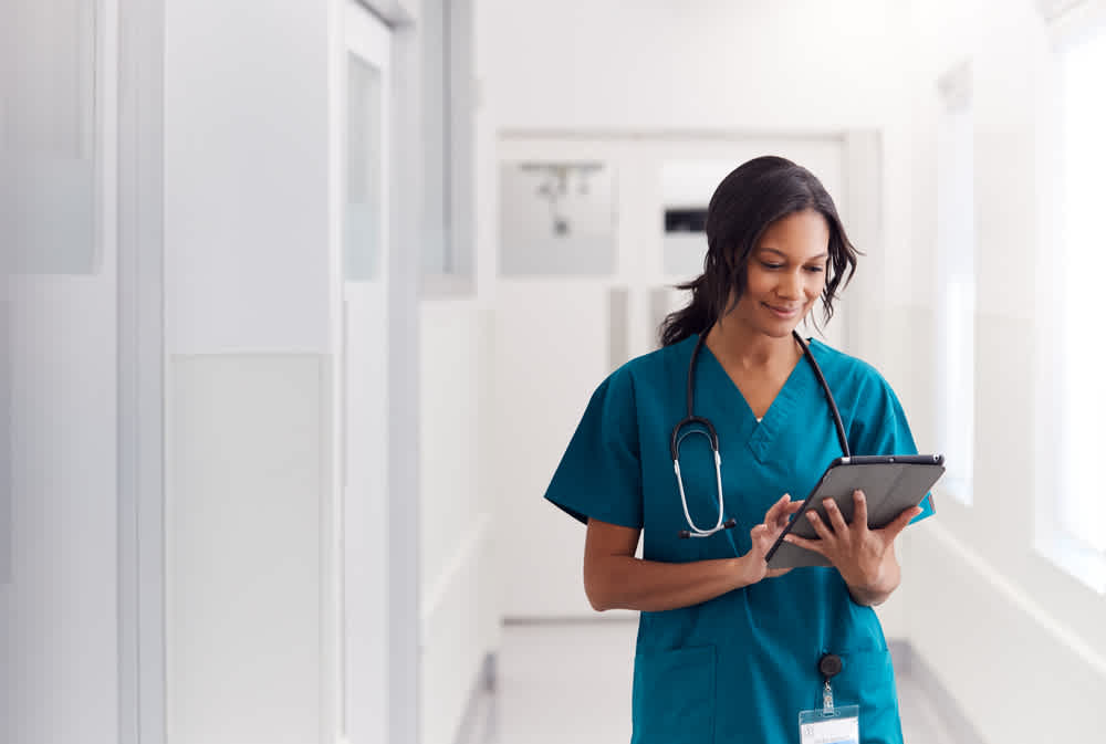 Nurse walking through a hospital corridor