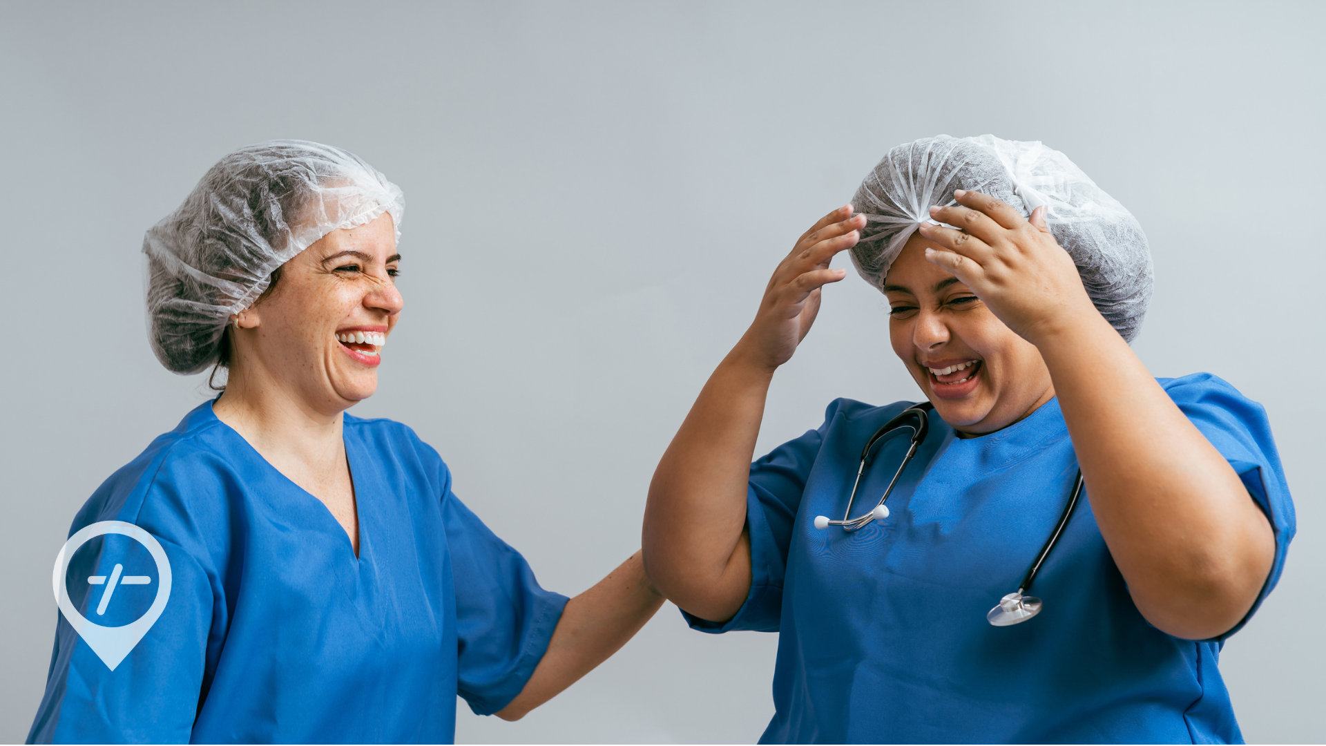 Two nurses laughing together. 
