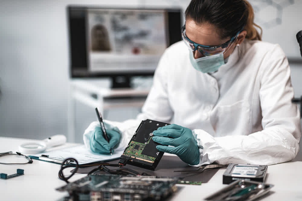 Forensic nurse examining hard drive