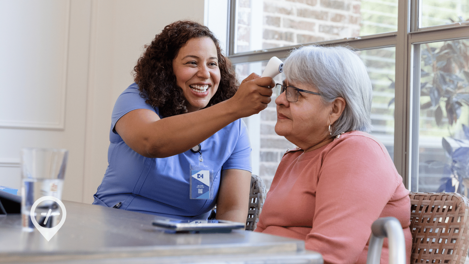 A nurse taking a resident's temperature inside a nursing home.