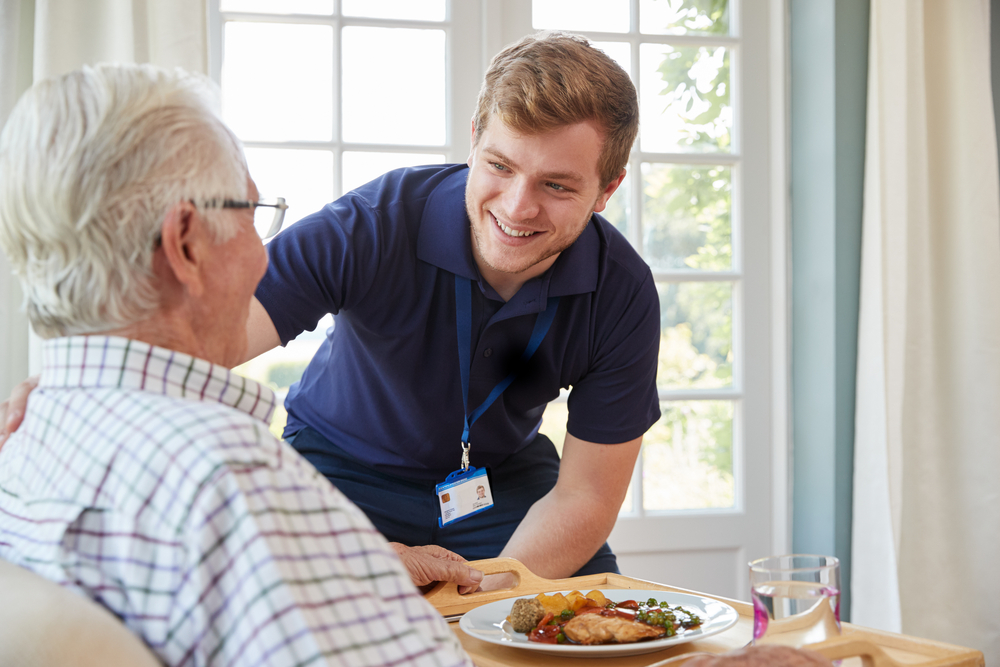 Home health nurse talking to an older person