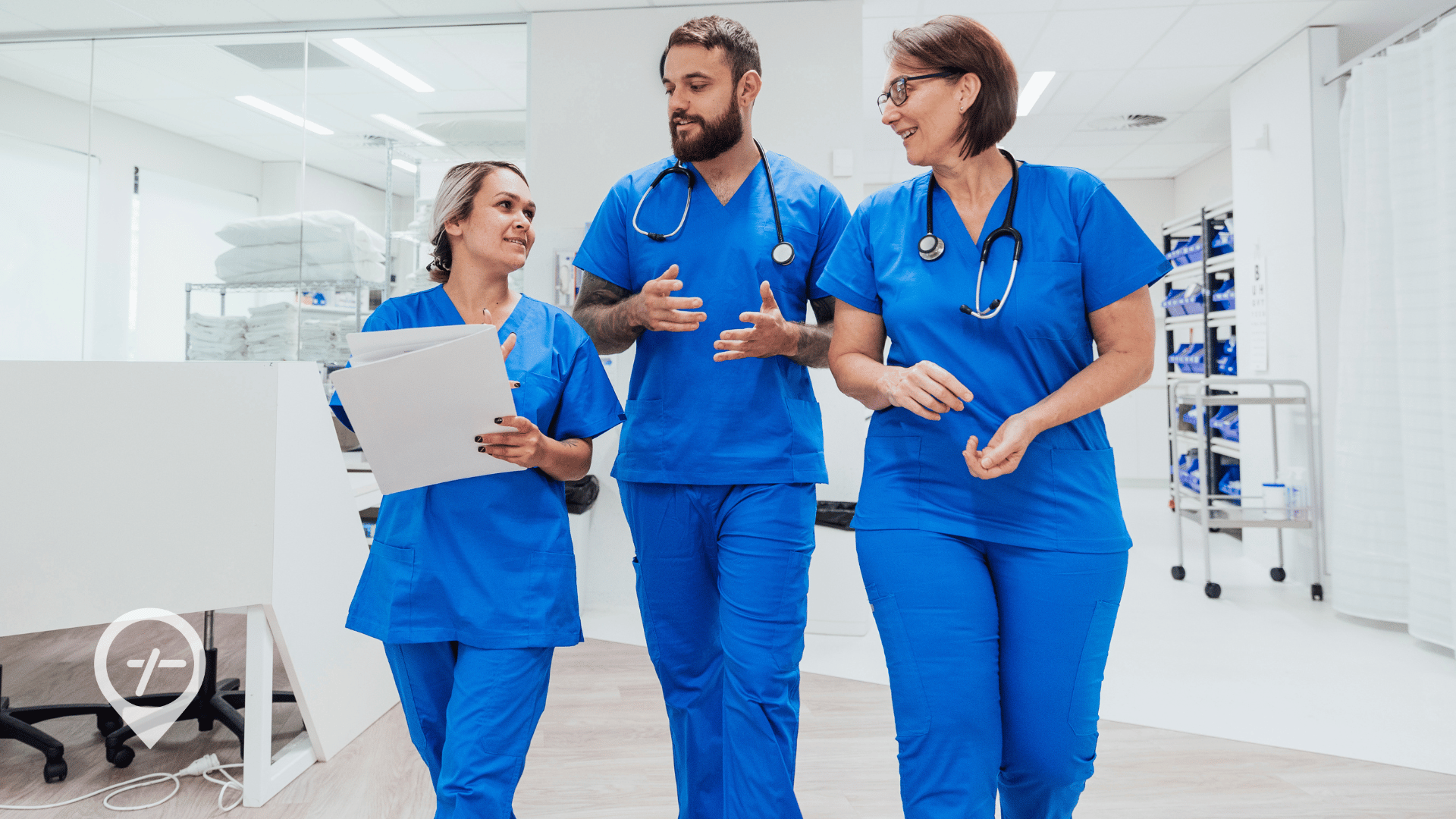 An image of three nurses walking down a hospital hallway.