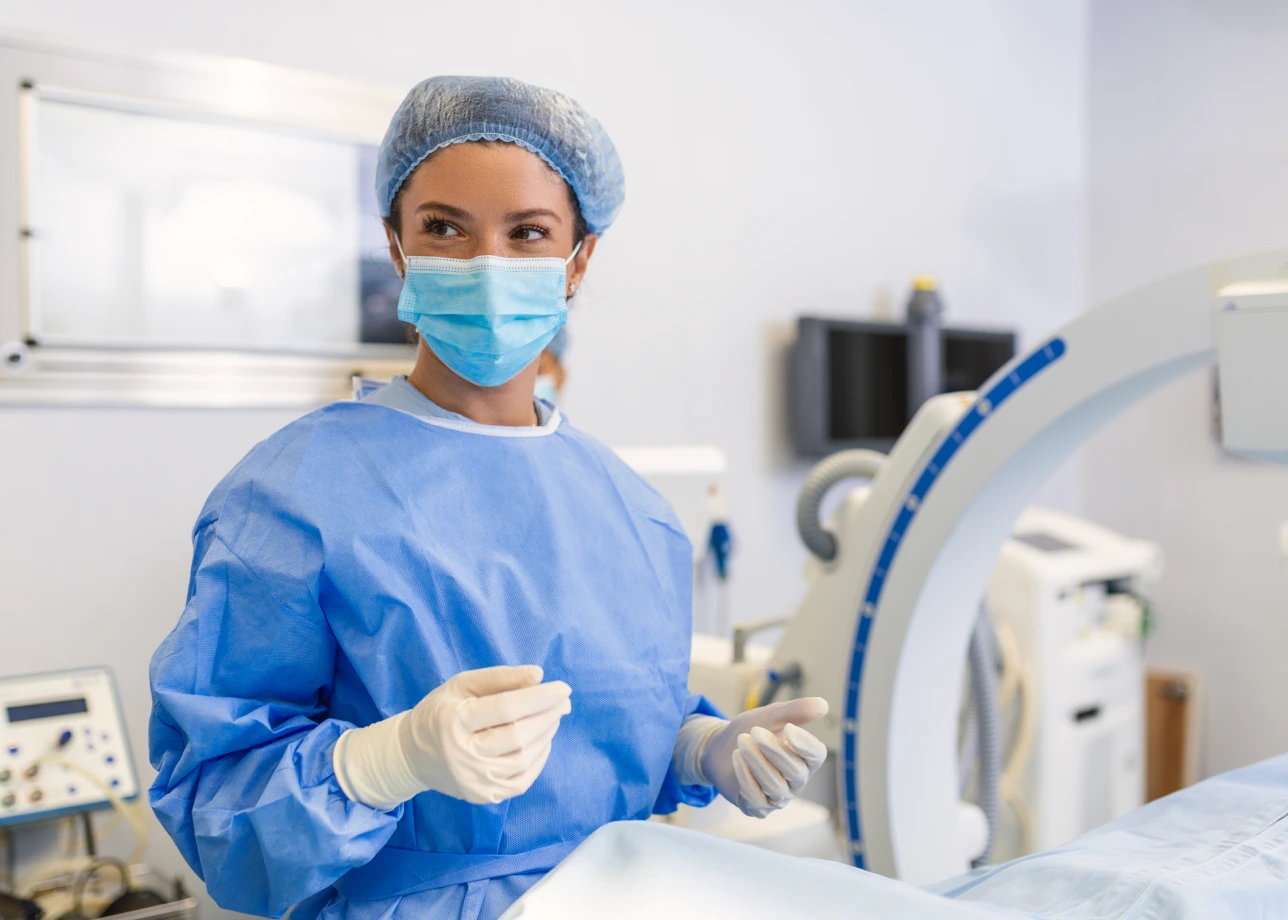 nurse in scrubs and gloves at a hospital