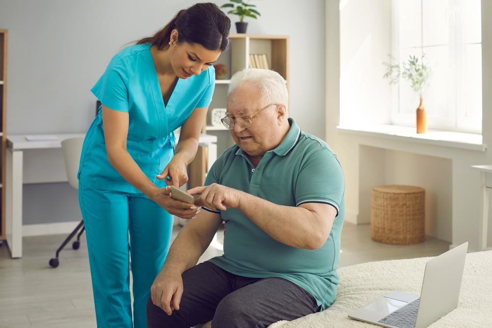 Home Health Aide (HHA) with an elderly patient in the hospital