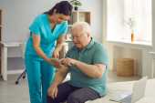 Home Health Aide (HHA) with an elderly patient in the hospital