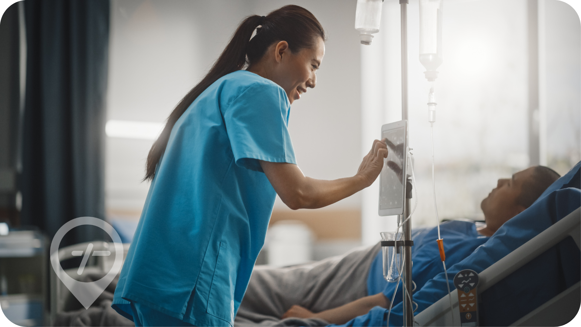 Female Asian nurse assists patient in a hospital ICU