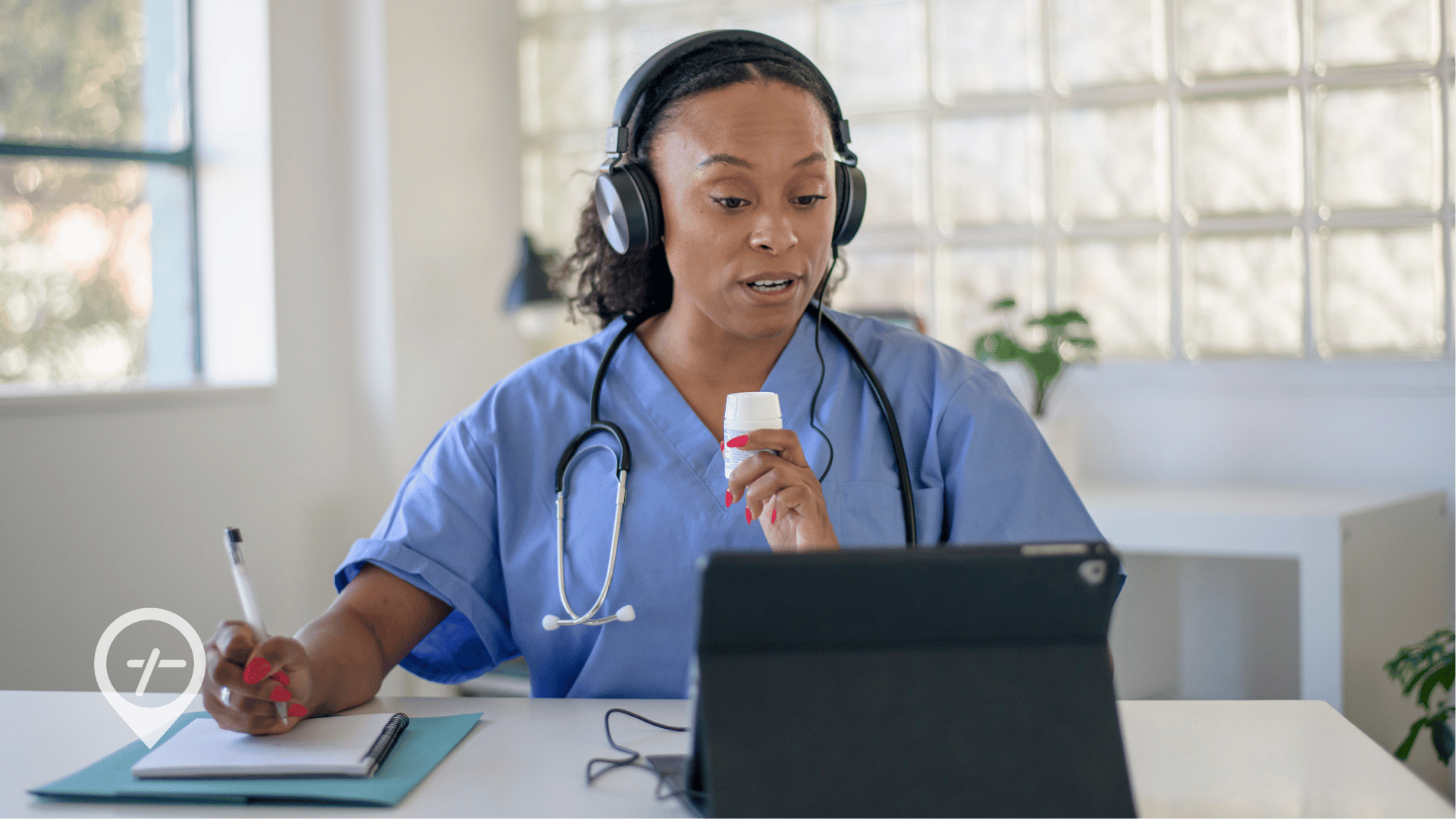 A nurse sits at a desk with a medicine bottle in her hand and talks to a patient during a telehealth visit.