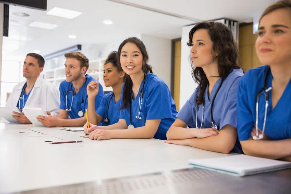 Nurses in class listening to doctor