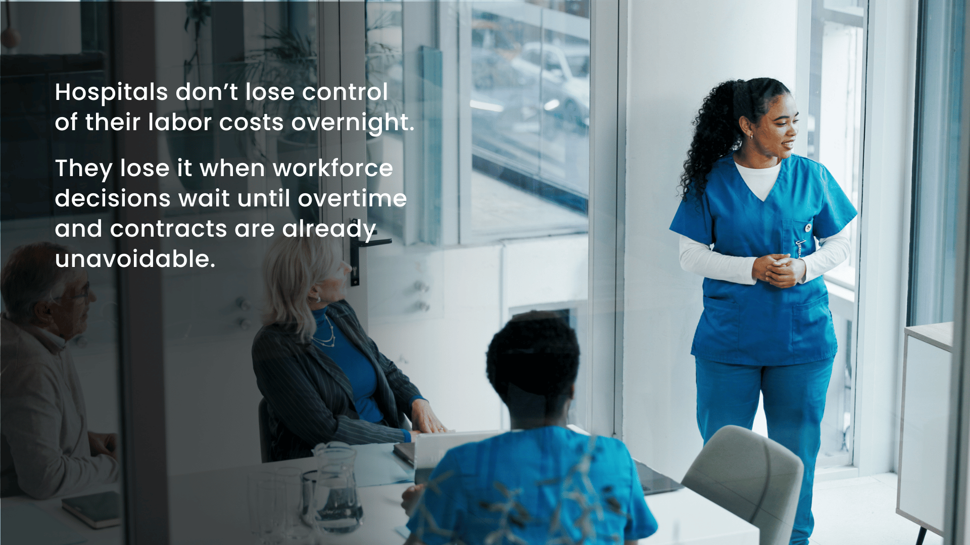 Clinical leaders and nurses discussing predictive staffing strategies to control hospital labor costs.