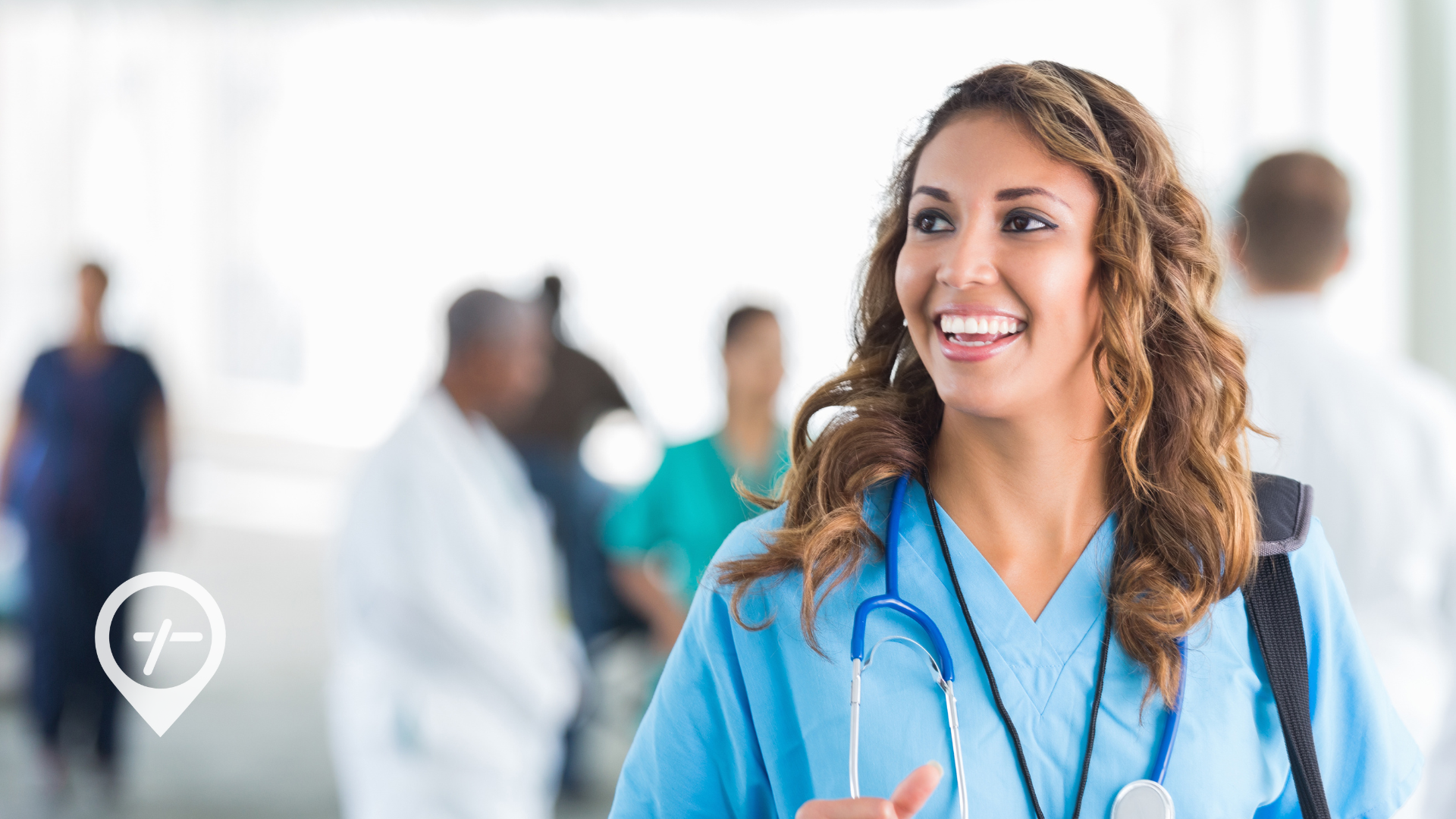 A nurse walking down the hall inside a hospital.