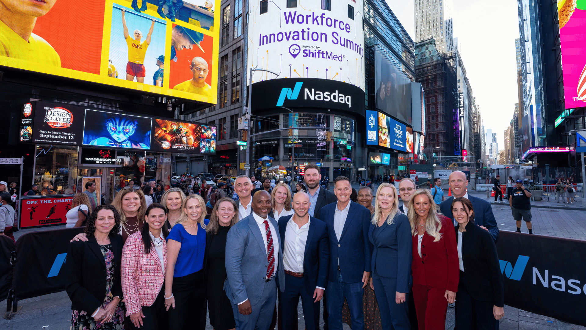 ShiftMed and health system executives stand in front of the Nasdaq sign in Times Square during the 2025 Workforce Innovation Summit.