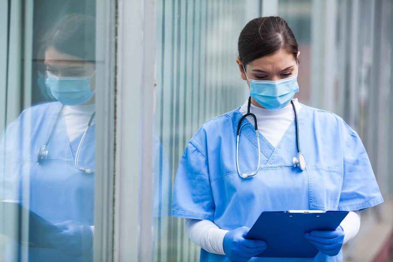 Triage nurse reviewing a patients file